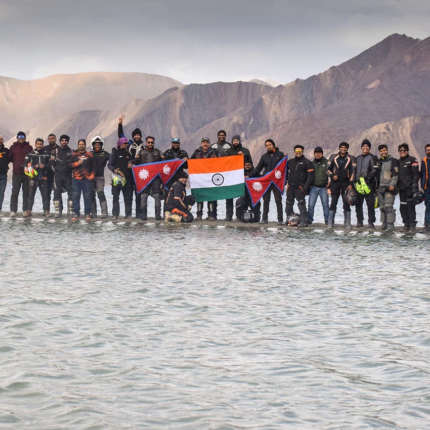 KTM Adventure 390 ride to Ladakh india flag at lake